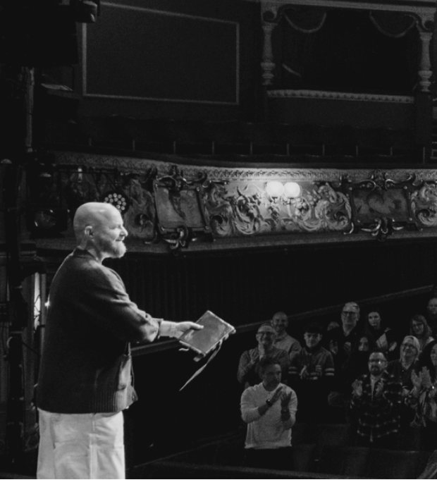 Luke Staton speaking on stage at Theatre Royal Wakefield.